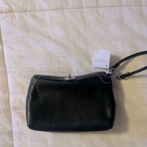 NWT Coach black leather wristlet with white stitching.